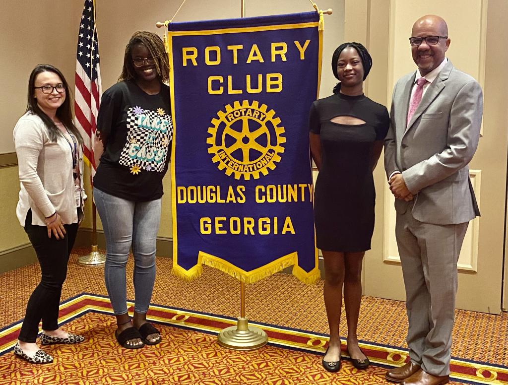 Rotary President Samantha Rosado, Hannah Byssainthe, Tiffany Grier, and Rotary Member and Douglas County School Superintendent Trent North.