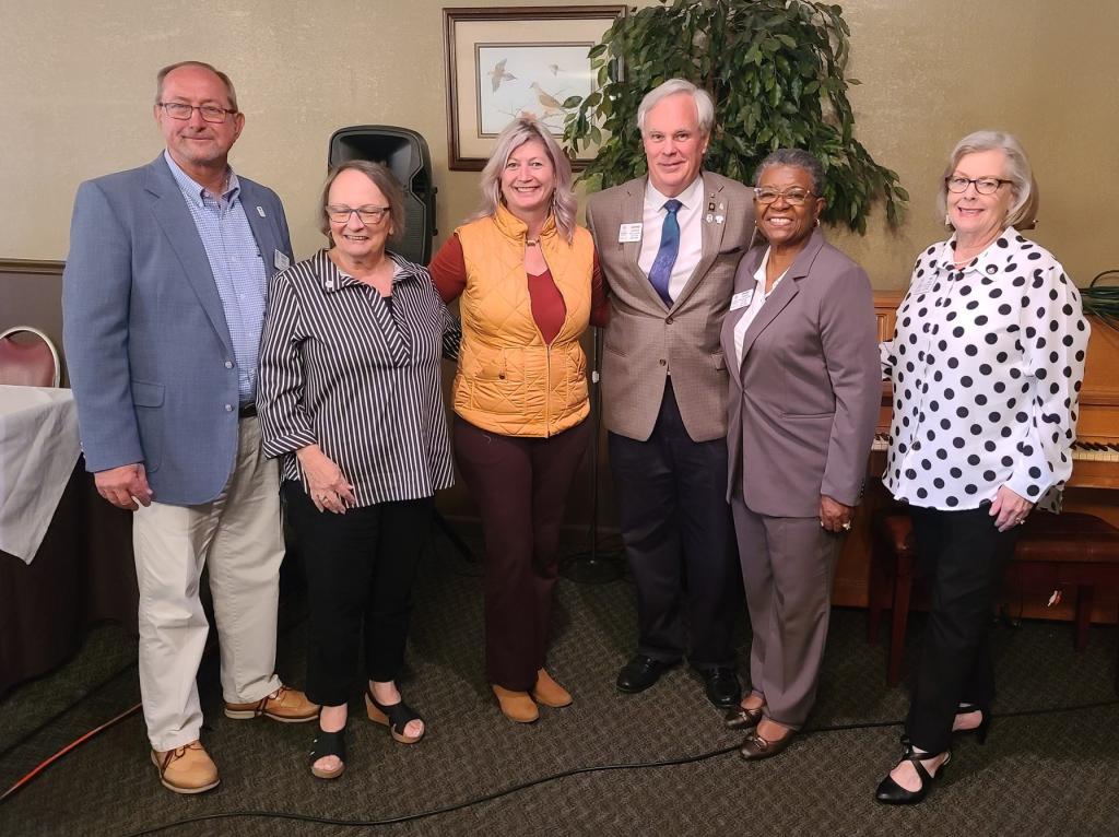 DG George with Thomasville Rotarians receiving the governor's award coin Danny Braddy, Fran Milberg Mary Beth Donaldson, DGE Andre Marria, and Teri Hurst White