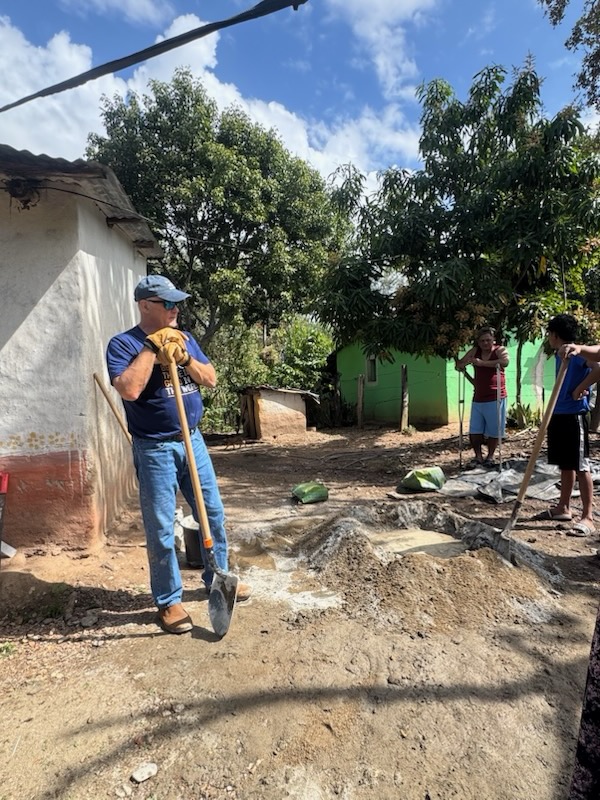 Ron Hand mixing cement.jpg