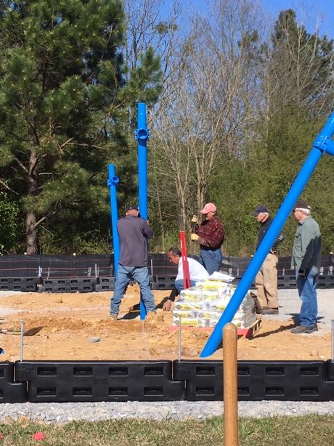 31 Placing swingset poles.JPG