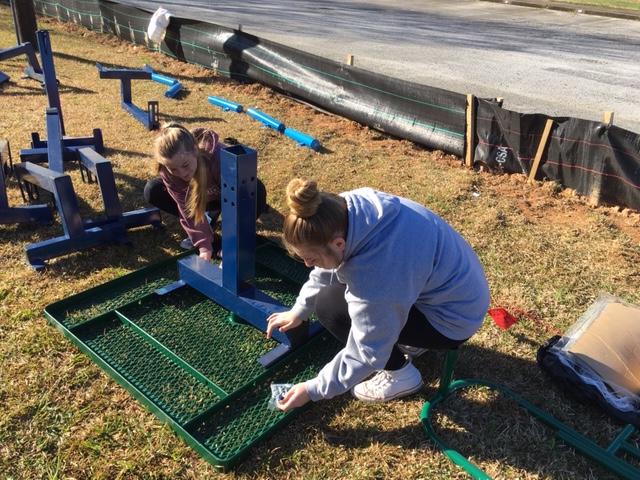 36 interact girls constructing picnic tables.JPG